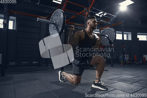 Image of The male athlete training hard in the gym. Fitness and healthy life concept.