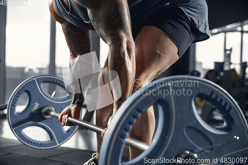 Image of The male athlete training hard in the gym. Fitness and healthy life concept.