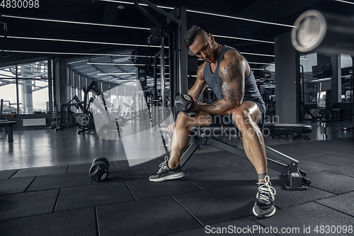 Image of The male athlete training hard in the gym. Fitness and healthy life concept.