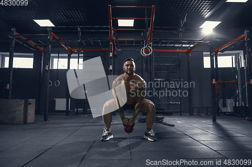 Image of The male athlete training hard in the gym. Fitness and healthy life concept.