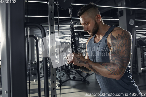 Image of The male athlete training hard in the gym. Fitness and healthy life concept.