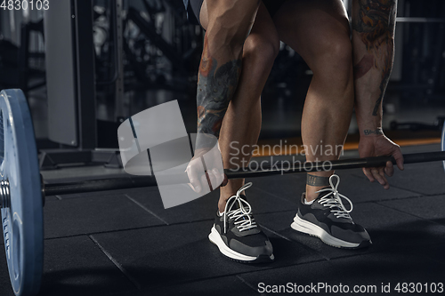 Image of The male athlete training hard in the gym. Fitness and healthy life concept.