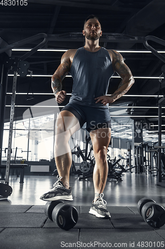 Image of The male athlete training hard in the gym. Fitness and healthy life concept.