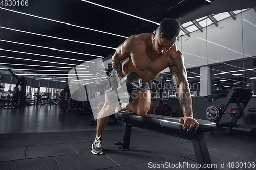 Image of The male athlete training hard in the gym. Fitness and healthy life concept.