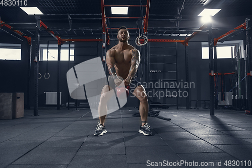 Image of The male athlete training hard in the gym. Fitness and healthy life concept.