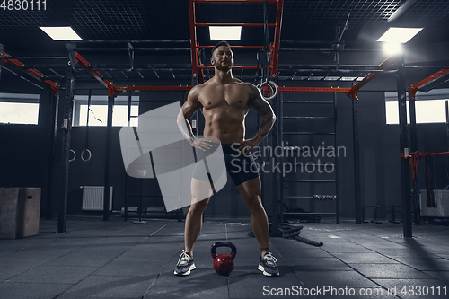 Image of The male athlete training hard in the gym. Fitness and healthy life concept.