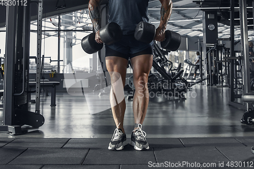 Image of The male athlete training hard in the gym. Fitness and healthy life concept.