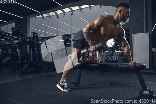 Image of The male athlete training hard in the gym. Fitness and healthy life concept.