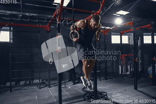 Image of The male athlete training hard in the gym. Fitness and healthy life concept.