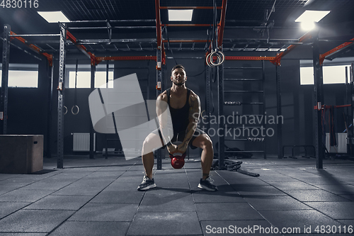 Image of The male athlete training hard in the gym. Fitness and healthy life concept.