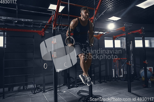 Image of The male athlete training hard in the gym. Fitness and healthy life concept.