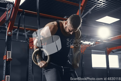 Image of The male athlete training hard in the gym. Fitness and healthy life concept.