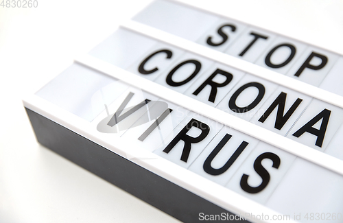 Image of close up of lightbox with stop corona virus words