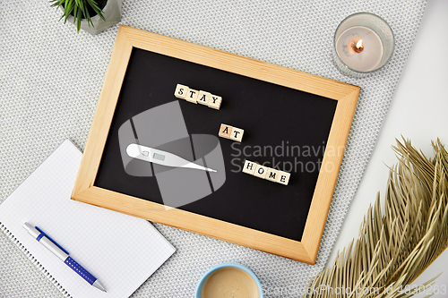 Image of chalkboard with stay at home words on toy blocks