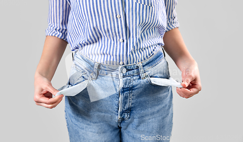 Image of close up of woman showing empty pockets