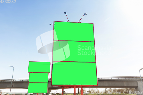 Image of big billboard with green chroma key screen in city