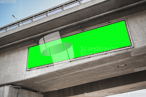 Image of billboard with green chroma key screen on bridge