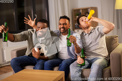 Image of friends or soccer fans with ball and beer at home