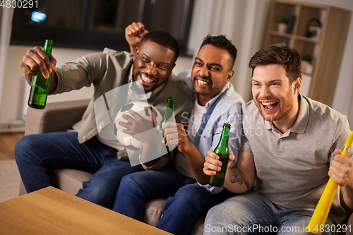 Image of friends or soccer fans with ball and beer at home