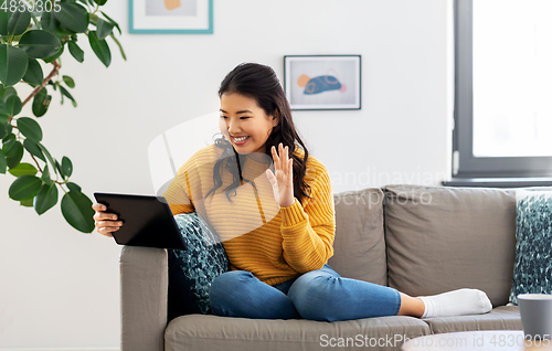 Image of woman with tablet pc having video call at home