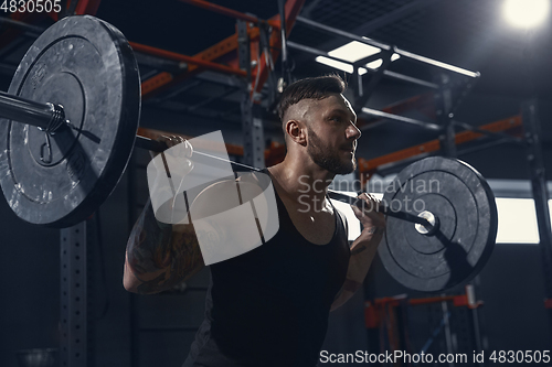 Image of The male athlete training hard in the gym. Fitness and healthy life concept.