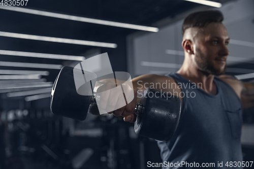 Image of The male athlete training hard in the gym. Fitness and healthy life concept.