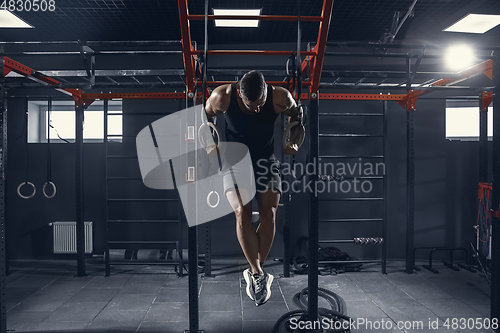 Image of The male athlete training hard in the gym. Fitness and healthy life concept.