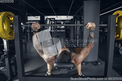 Image of The male athlete training hard in the gym. Fitness and healthy life concept.