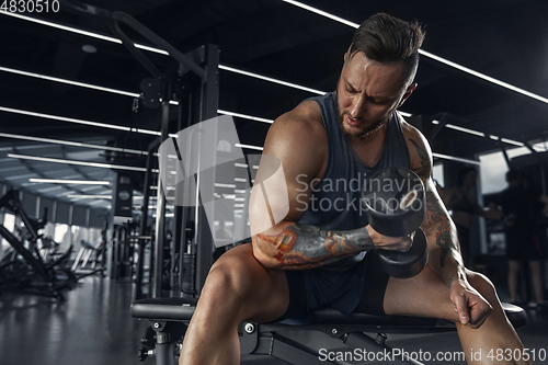 Image of The male athlete training hard in the gym. Fitness and healthy life concept.