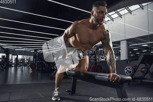 Image of The male athlete training hard in the gym. Fitness and healthy life concept.