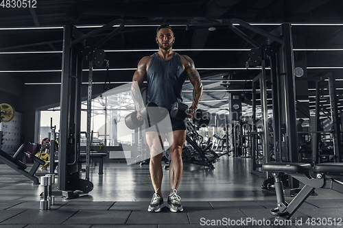 Image of The male athlete training hard in the gym. Fitness and healthy life concept.