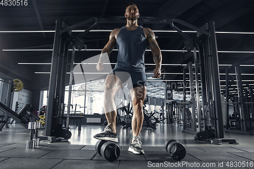 Image of The male athlete training hard in the gym. Fitness and healthy life concept.