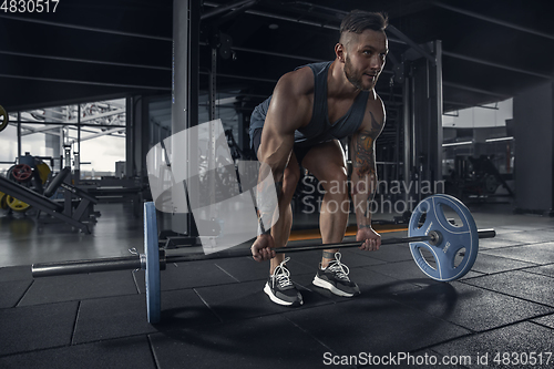 Image of The male athlete training hard in the gym. Fitness and healthy life concept.