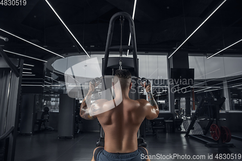Image of The male athlete training hard in the gym. Fitness and healthy life concept.