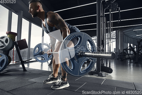 Image of The male athlete training hard in the gym. Fitness and healthy life concept.