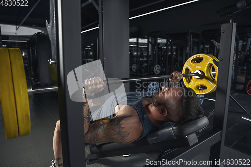 Image of The male athlete training hard in the gym. Fitness and healthy life concept.