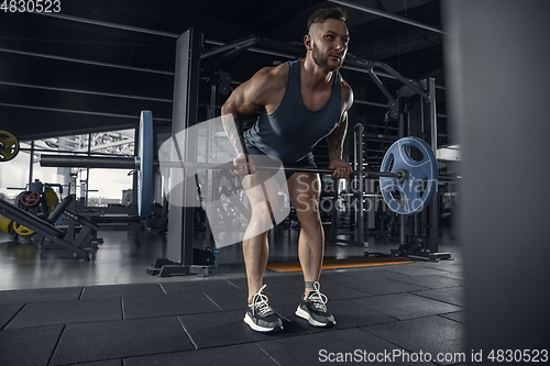 Image of The male athlete training hard in the gym. Fitness and healthy life concept.