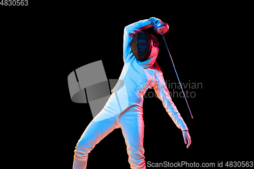 Image of Teen girl in fencing costume with sword in hand isolated on black background