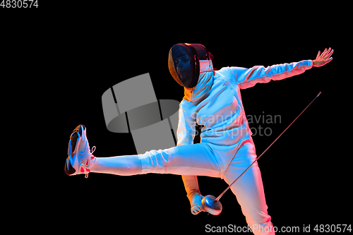 Image of Teen girl in fencing costume with sword in hand isolated on black background