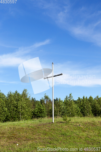 Image of metal cross in the wood