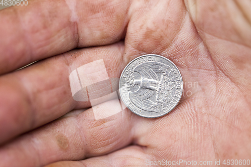 Image of American coin in hand