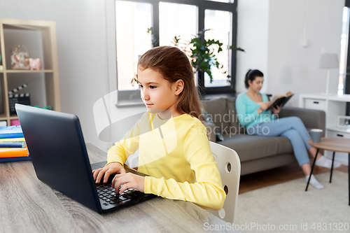 Image of student girl with laptop learning online at home