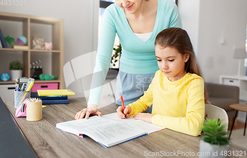 Image of mother and daughter doing homework together