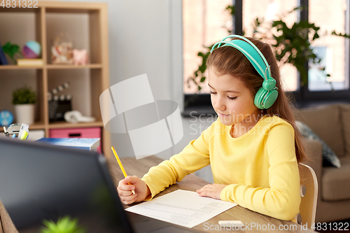 Image of student girl doing school test at home