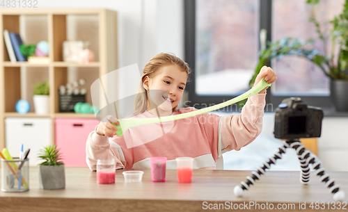 Image of girl with slime and camera video blogging at home