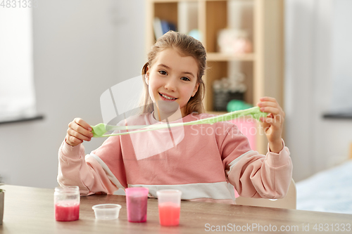 Image of girl playing with slime at home