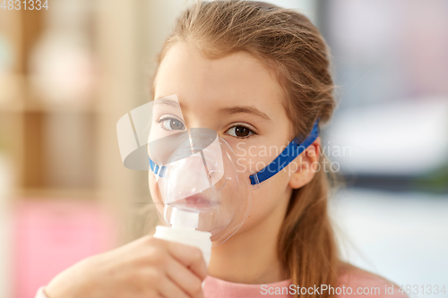 Image of sick little girl wearing oxygen mask