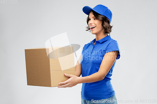 Image of happy delivery girl with parcel box in blue