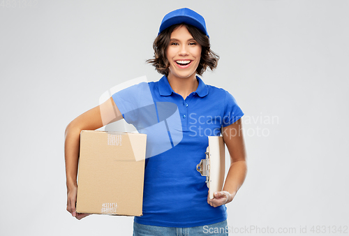 Image of happy delivery girl with parcel box and clipboard