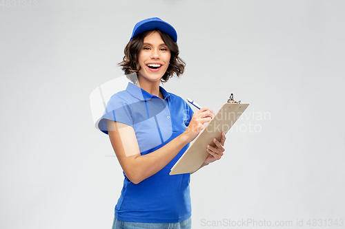 Image of happy delivery girl with clipboard and pen writing